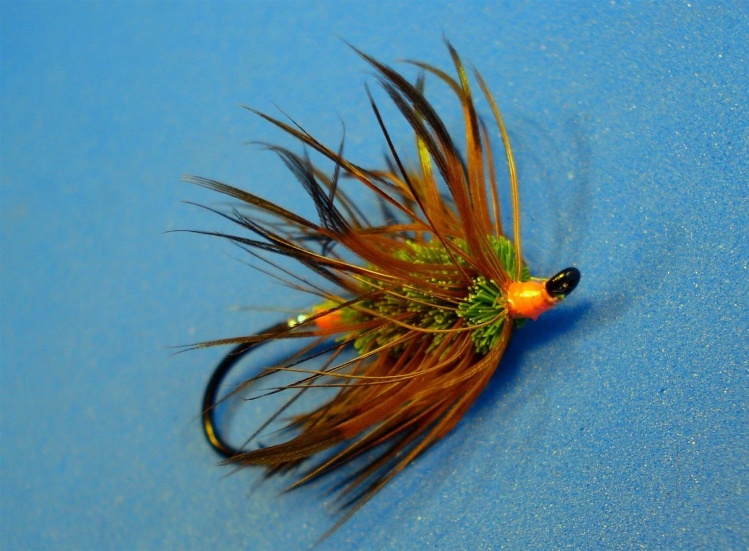 Green Machine 
Hook: up turned salmon light wire (TMC 7999). Tag: silver tinsel / pink floss or thread. Body: green deer body. Hackle: brown rooster saddle. Head: same as tag.