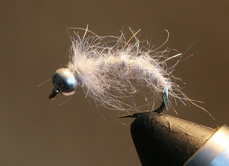 A nymph with a darker underbody (different colors) and white layer out of acrylic dubbing. In the water this upper layer becomes translucent, and the nymph looks like a real bug.