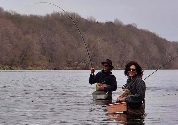 Jody and Pat on the river fishing for shad, Jody is on!
