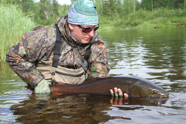 Nikolay Samondrosov with taimen 15 lb  Russia.   the fish must be treated very gently then she will long to please us. www.trueadventure.ru