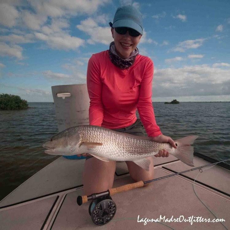 Janessa with an oversized redfish we found swimming with its back out of the water