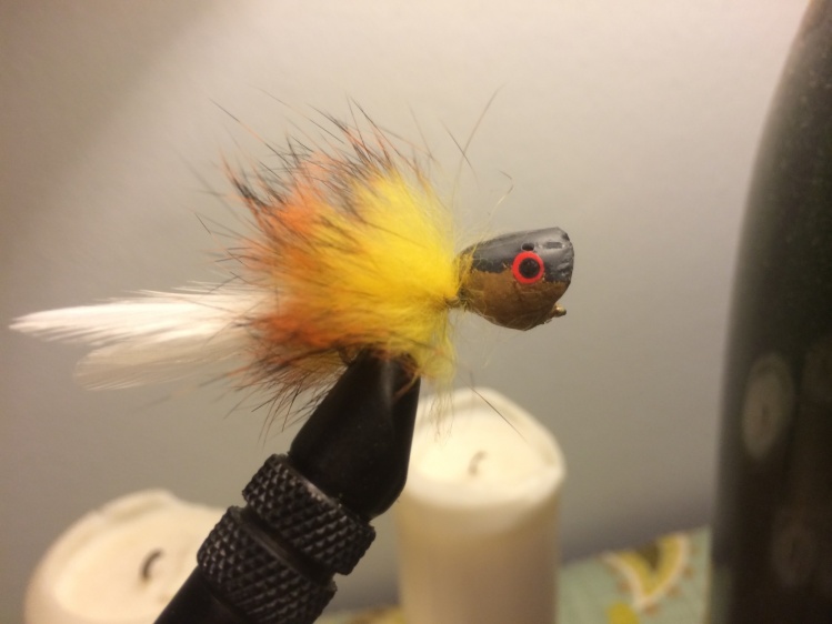 Panfish popper. Carved wine cork, painted and epoxied. Rabbit strip and saddle hackle