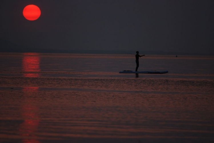 Never too late to be out when there's no wind. looking for humpies and silvers on the paddleboard, productive day and great sunset. Photo credit: Chris Tompkins.