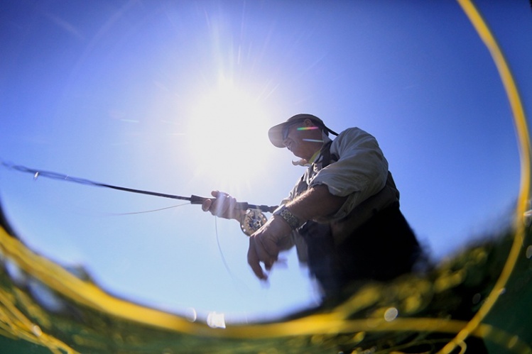 Fish-eye of an angler through the fly line.  Shooting from underwater gives such a great and different perspective on our sport.