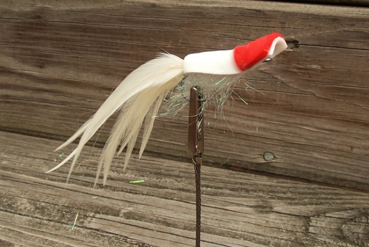 Gurgler on a size 2 long shank hook with feathers and flash in the tail and foam and EP Brush body. Double head in classic red and white colors.