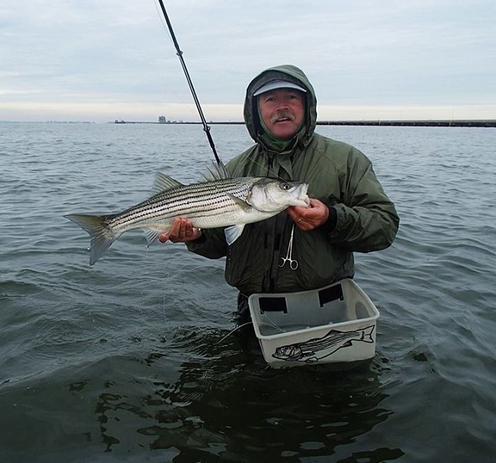 Hugh with a fall school striped bass taken on a white Cloused Minnow.