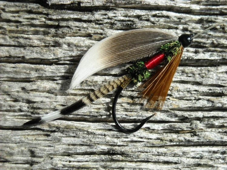 This is a variation of the "Royal Coachman" wet fly only tied with Perigord goose flank feathers for the wing. She's dressed on a #7 3370 marked shank with a 4lb silk gut snell.