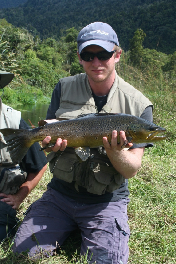Son with spring creek brown , NZ