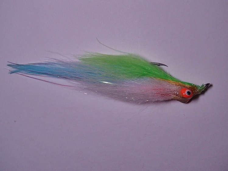 Again, this is my friend Joe's fly, we sat down one Sunday and tyed up his favorite pattern for stripers......here's my take. White bucktail for the tail, on top tented blue hackle with flash. Next palmer on marabou (in this case pink and yellow), red cac
